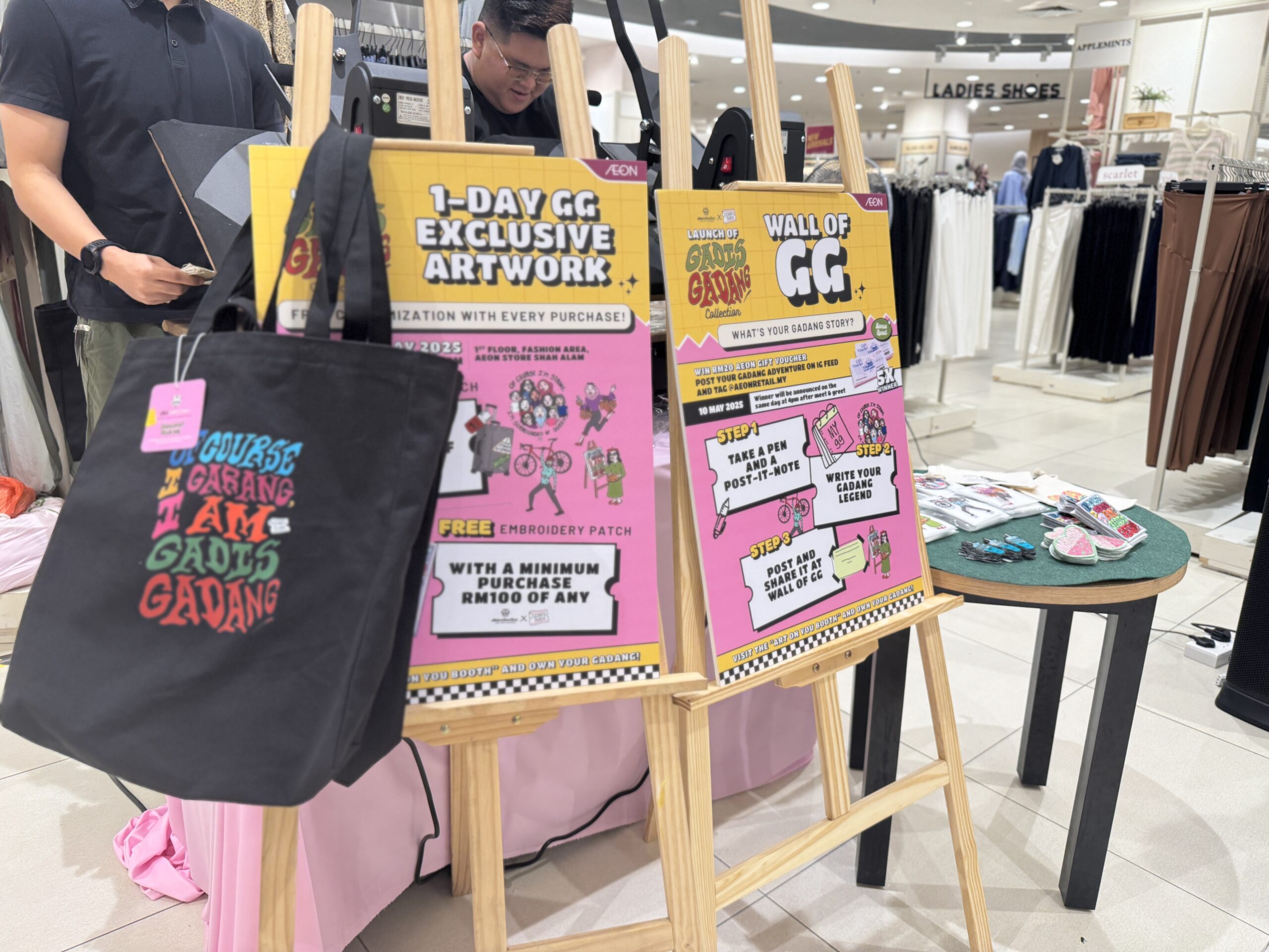 Staff performing heat transfer printing live at Pluscollection x Izzati Suza activation