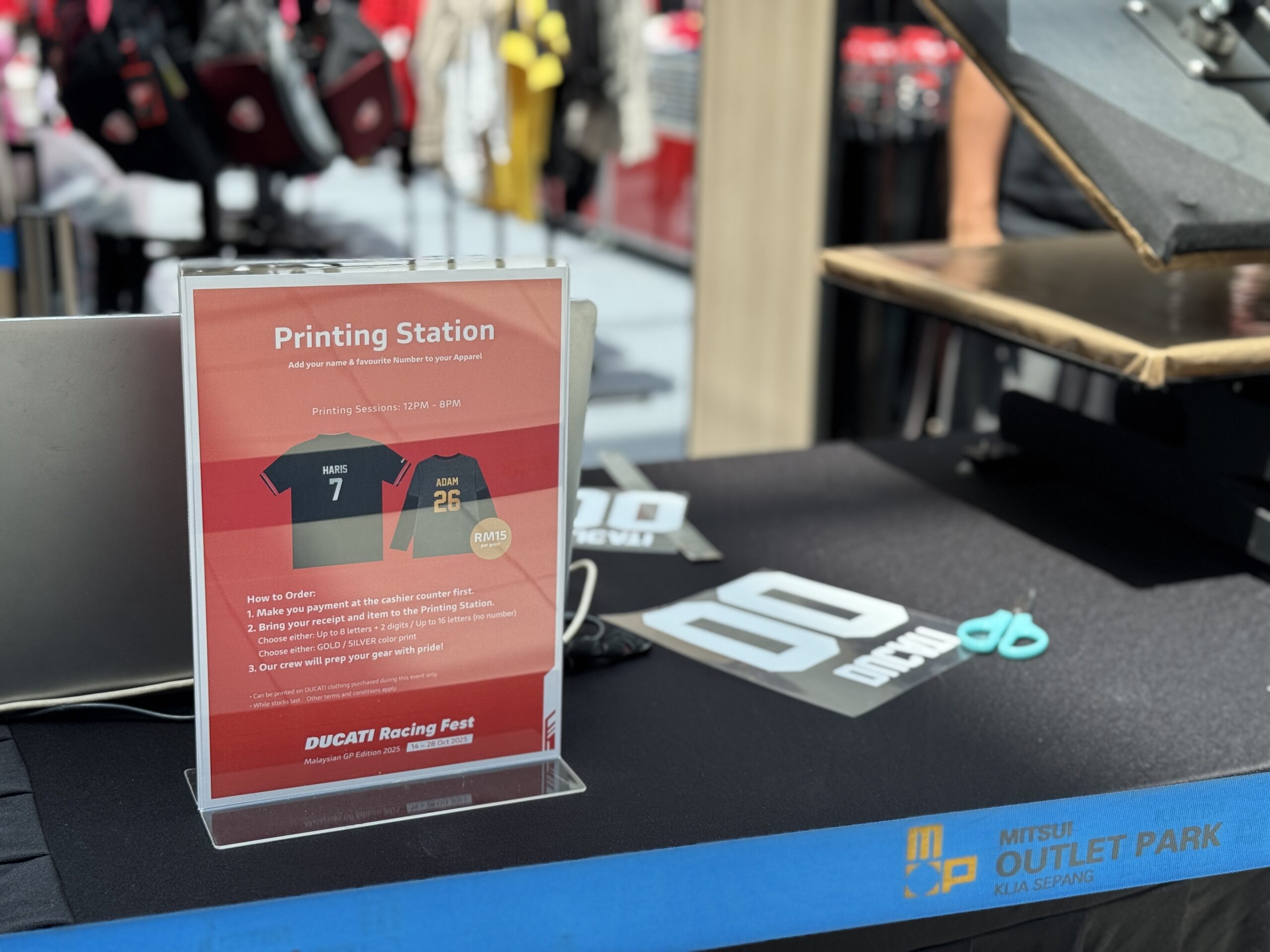 Queue of visitors at Ducati on-site t-shirt printing station